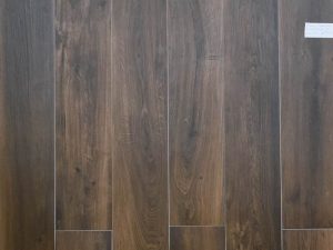 Wood look porcelain tile from Spain in dark brown color with some red hues for a warm style interior flooring.