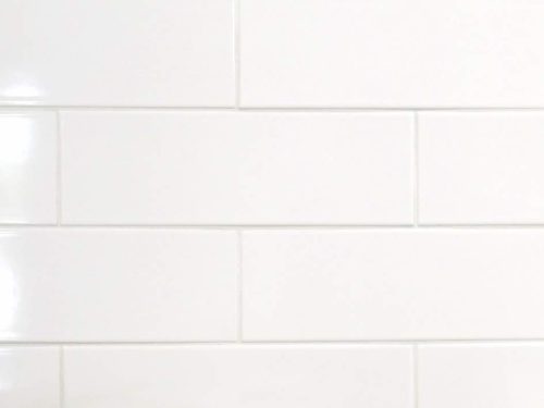 Large subway tile in white color for backsplash and bathroom walls to reduce the grout and bring in a cleaner look