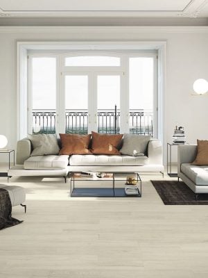 Mid century style living room with white walls and maple color wood looking tile floor
