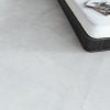 closeup picture of a light gray porcelain tile that has minimal design and looks like industrial style concrete floors.
