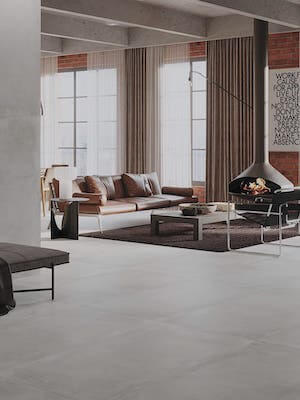 a modern style living room with light gray porcelain tile that looks like concrete floors