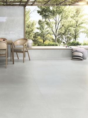 an industrial style floor with a 48x48 light gray color porcelain tile