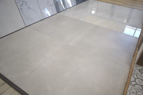 4 pieces of 48x48 light gray porcelain tile in a showroom floor